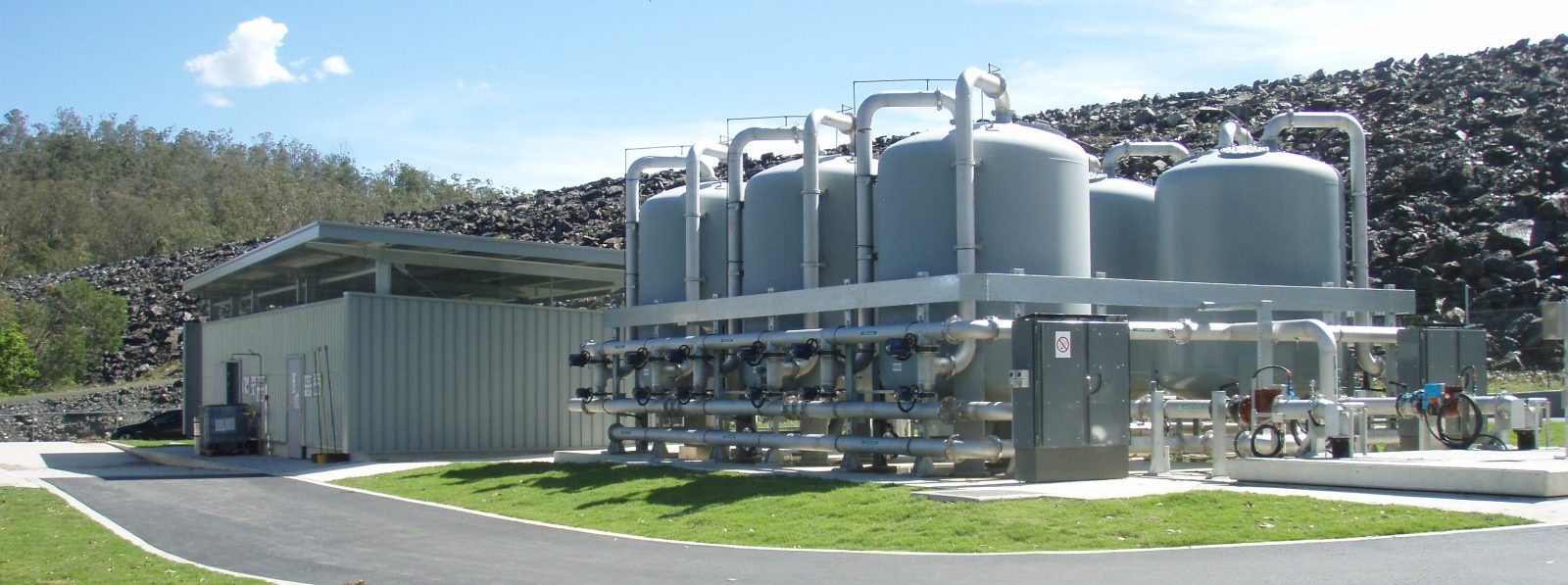 Row of pressure filter vessels with pipework and valves at the Enoggera water treatment plant