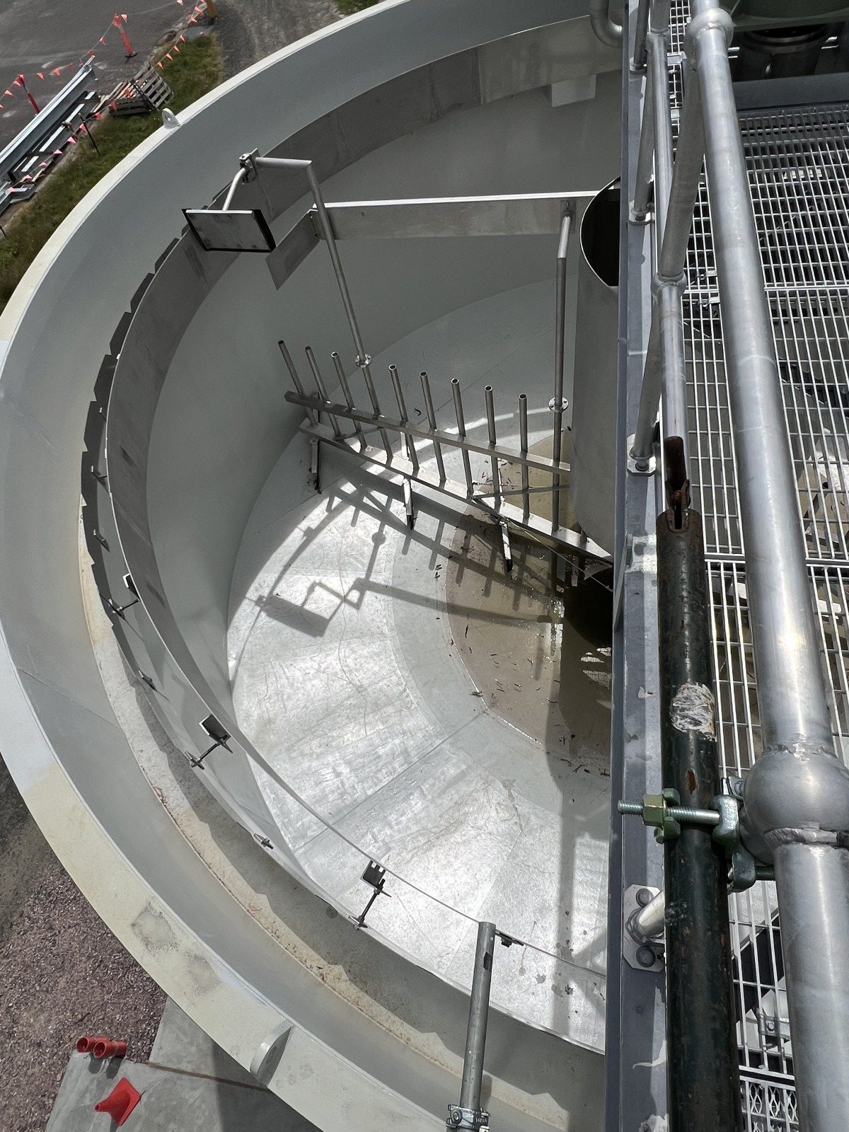 View into the empty Kingaroy sludge thickener tank, showing its picket rake and centre well