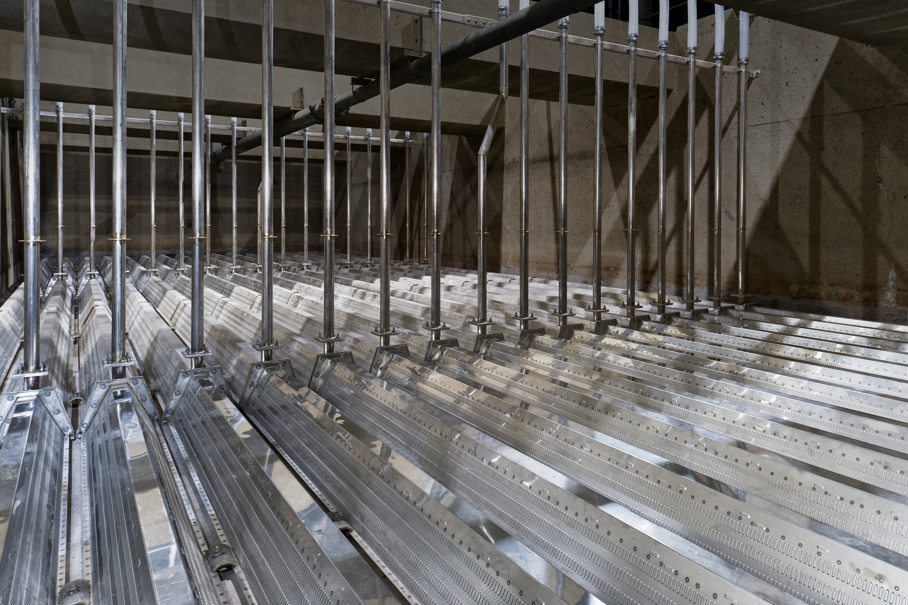 Stainless steel filter underdrain laterals with vertical riser pipes in an empty filter cell